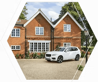 Large brick house gravel driveway white SUV